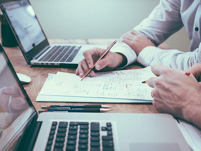 Amplify Capital will build a budget that will guide you to increased profitability Multiple people working on a budget